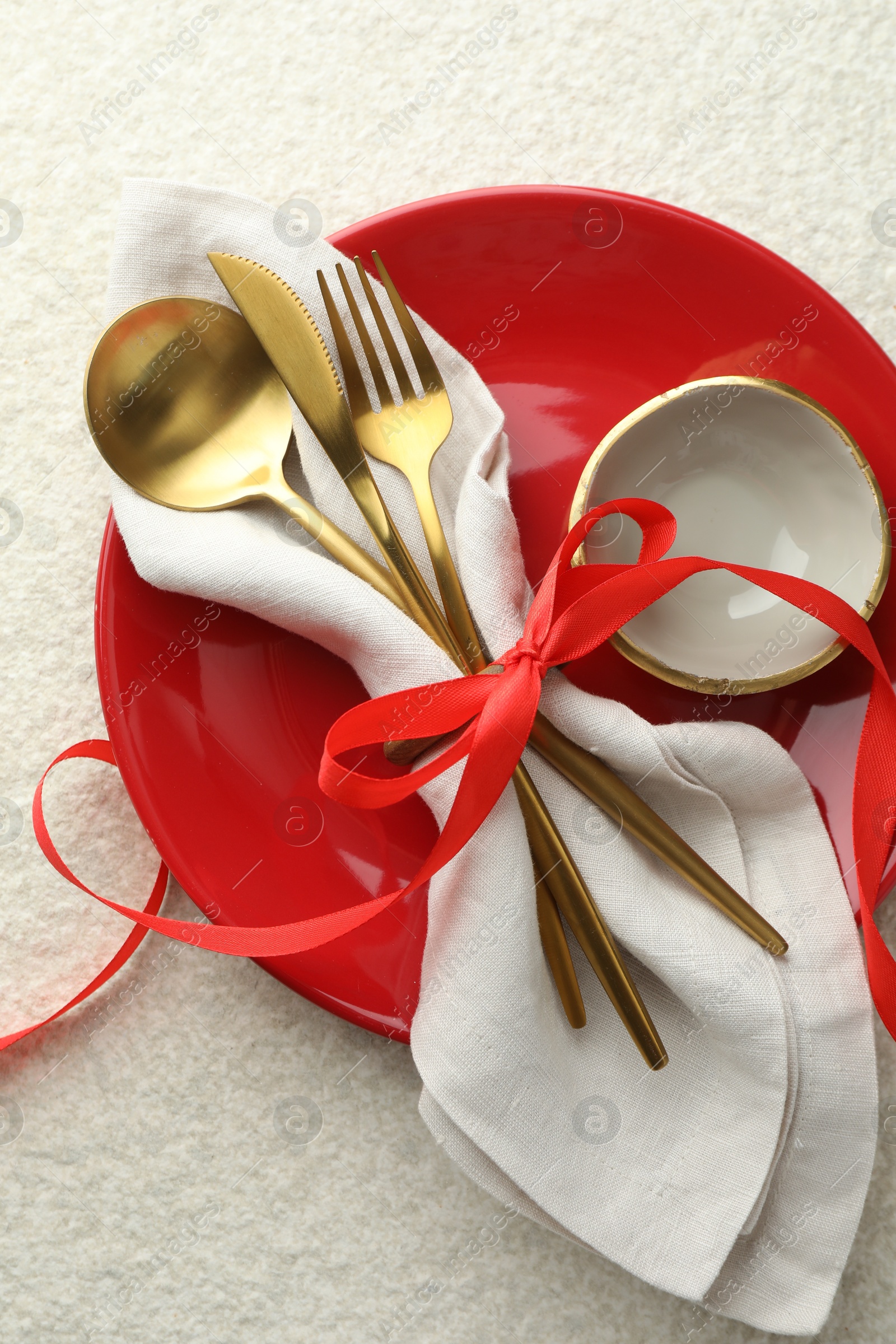 Photo of Christmas table setting with bowl, plate and cutlery, top view