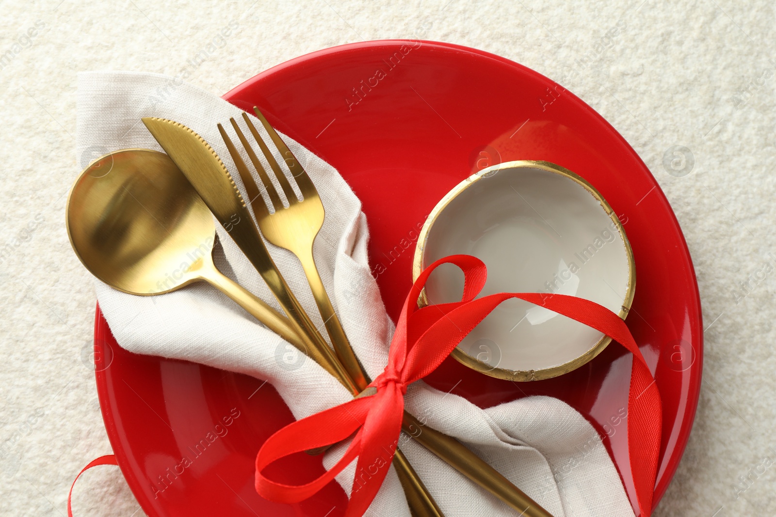 Photo of Christmas table setting with bowl, plate and cutlery, top view