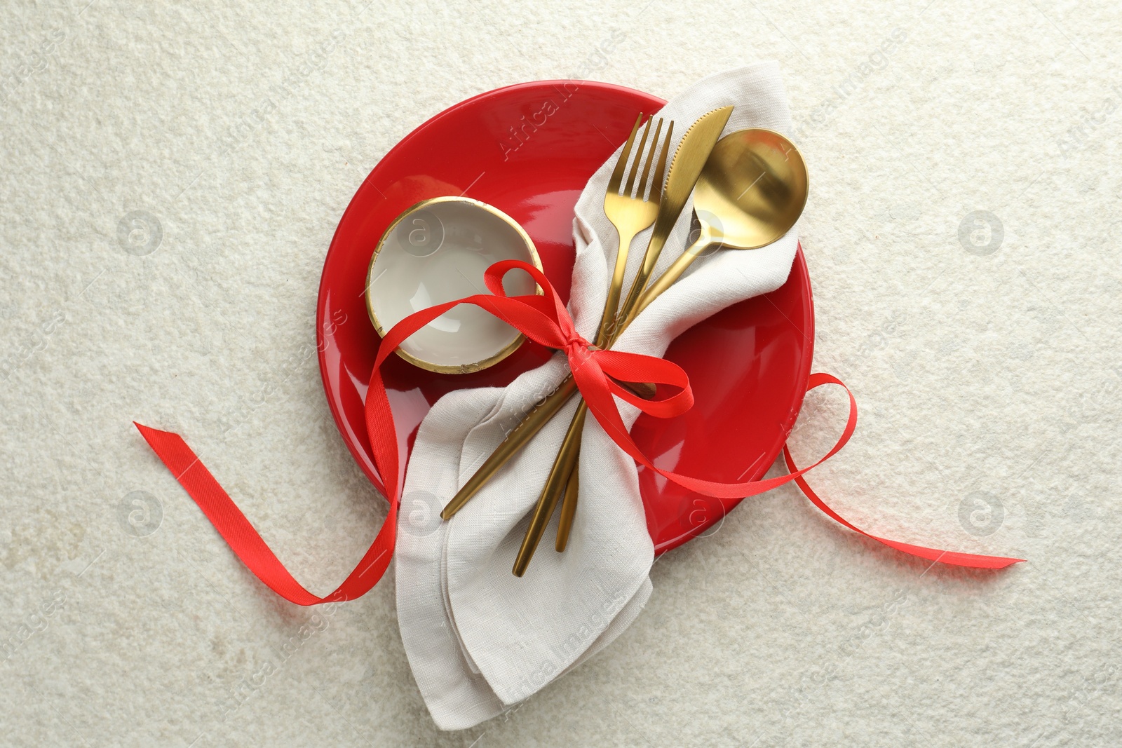 Photo of Christmas table setting with bowl, plate and cutlery, top view