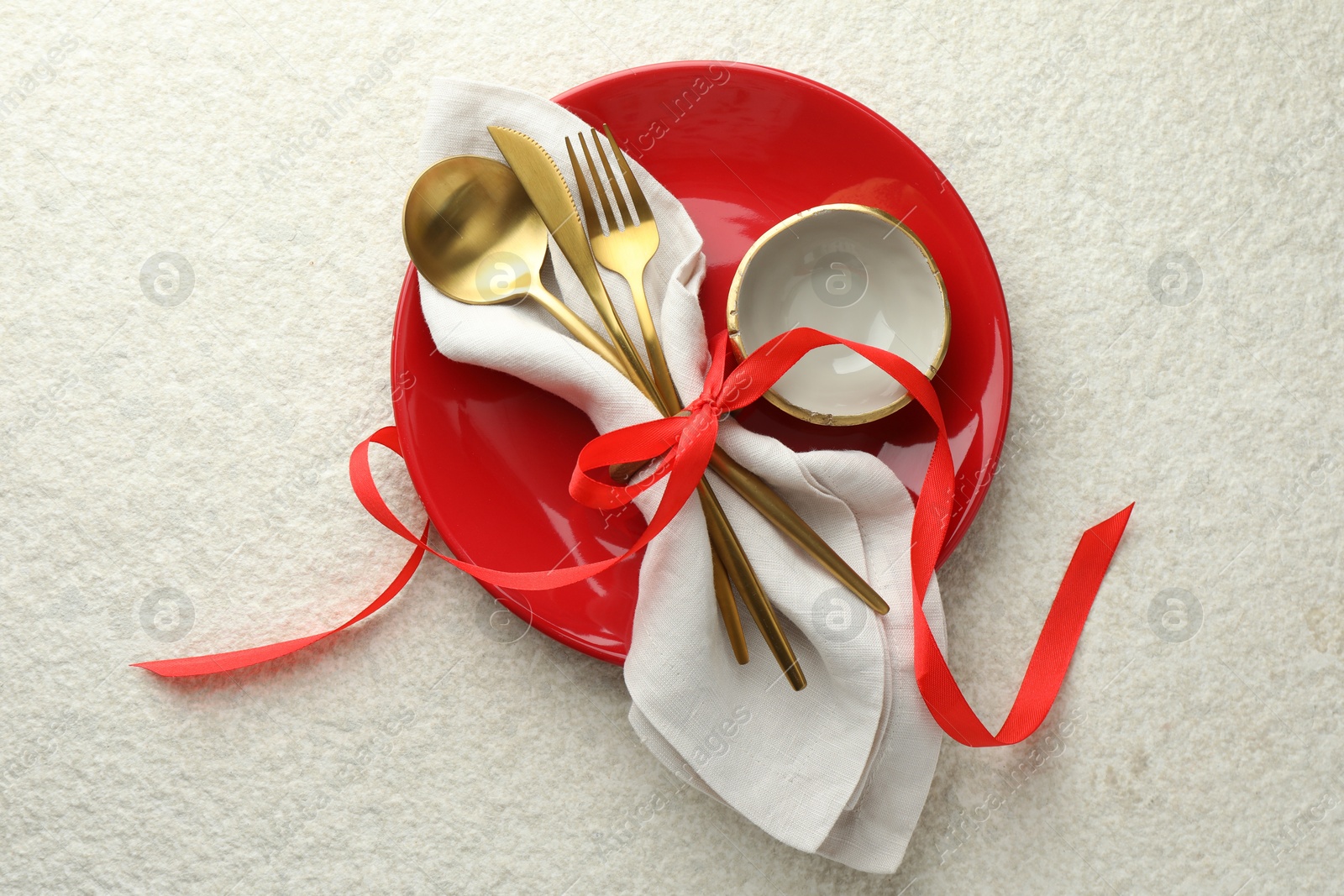 Photo of Christmas table setting with bowl, plate and cutlery, top view