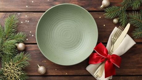 Photo of Christmas setting and festive decor on wooden table, flat lay