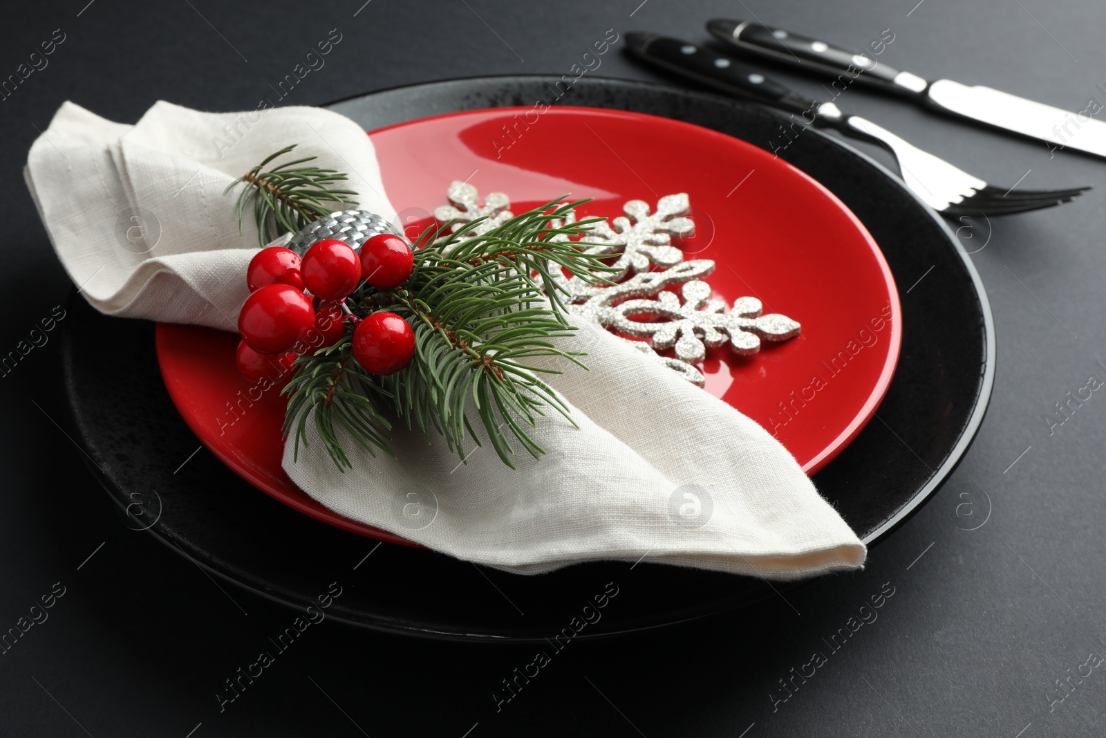 Photo of Christmas setting with festive decor on dark table, closeup