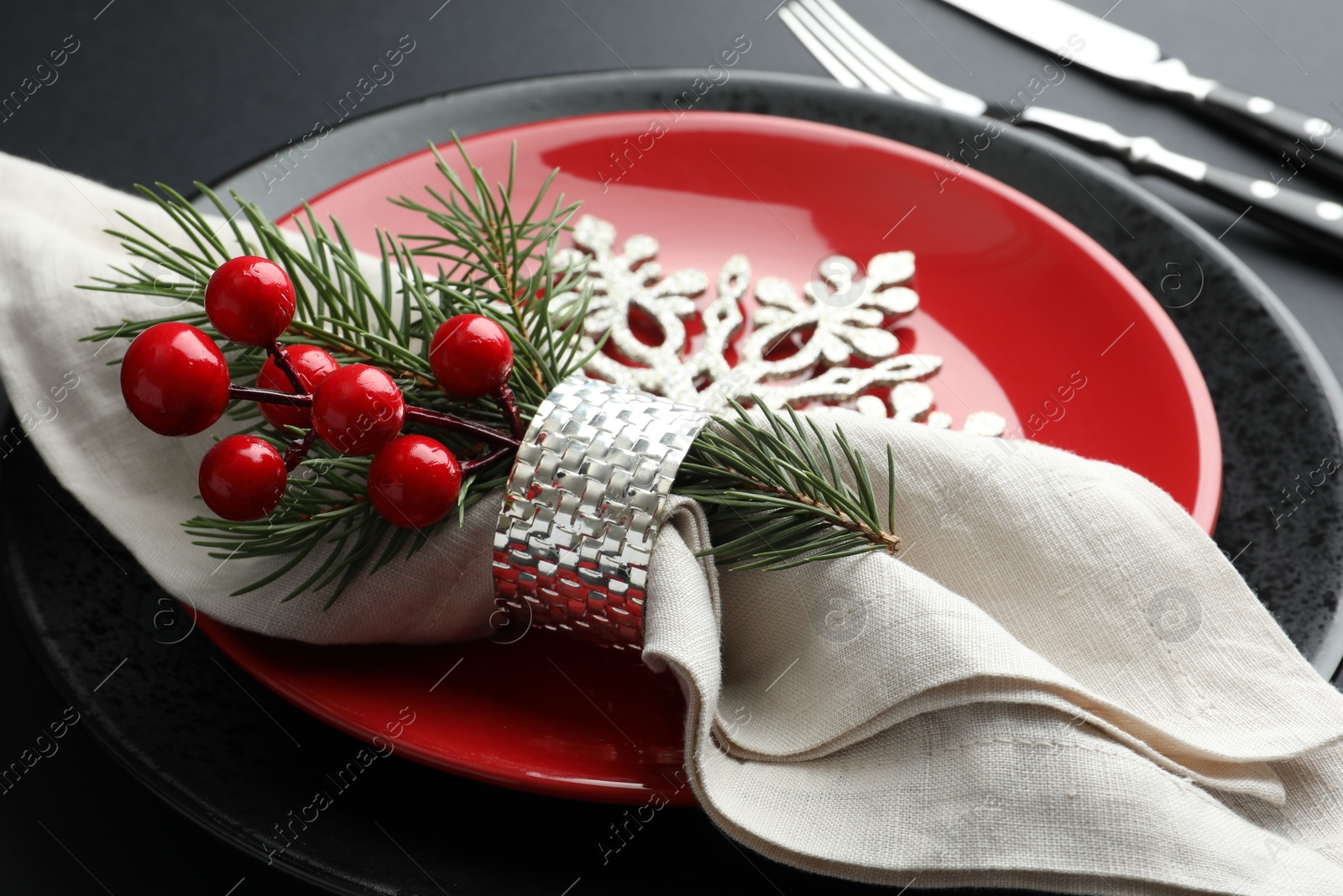 Photo of Christmas setting with festive decor on dark table, closeup