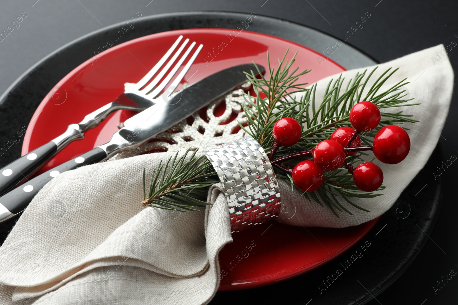 Photo of Christmas setting with festive decor on dark table, closeup