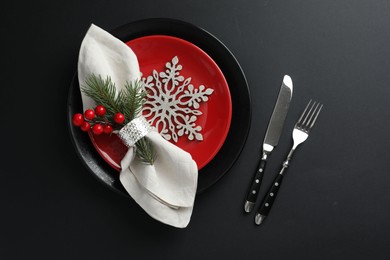 Photo of Christmas setting with festive decor on dark table, flat lay