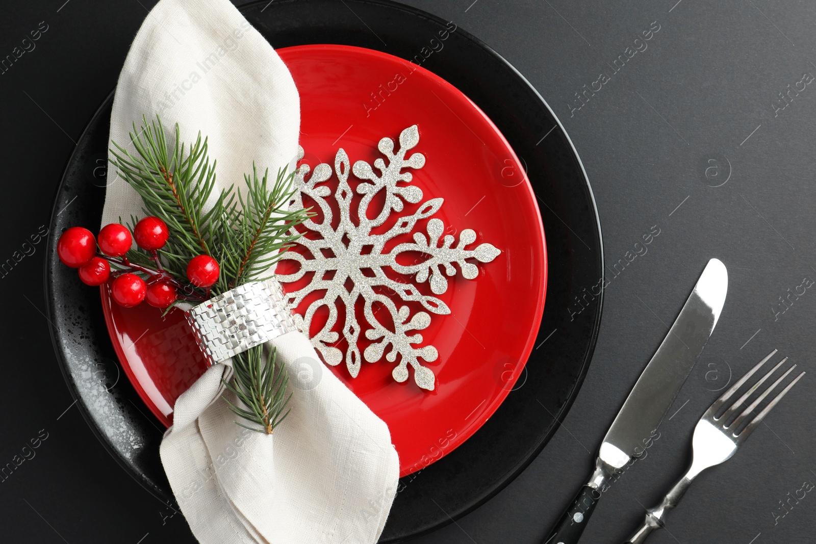 Photo of Christmas setting with festive decor on dark table, flat lay