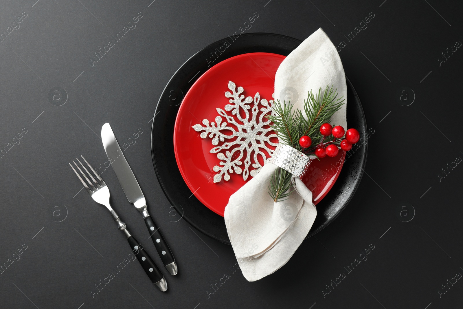 Photo of Christmas setting with festive decor on dark table, flat lay