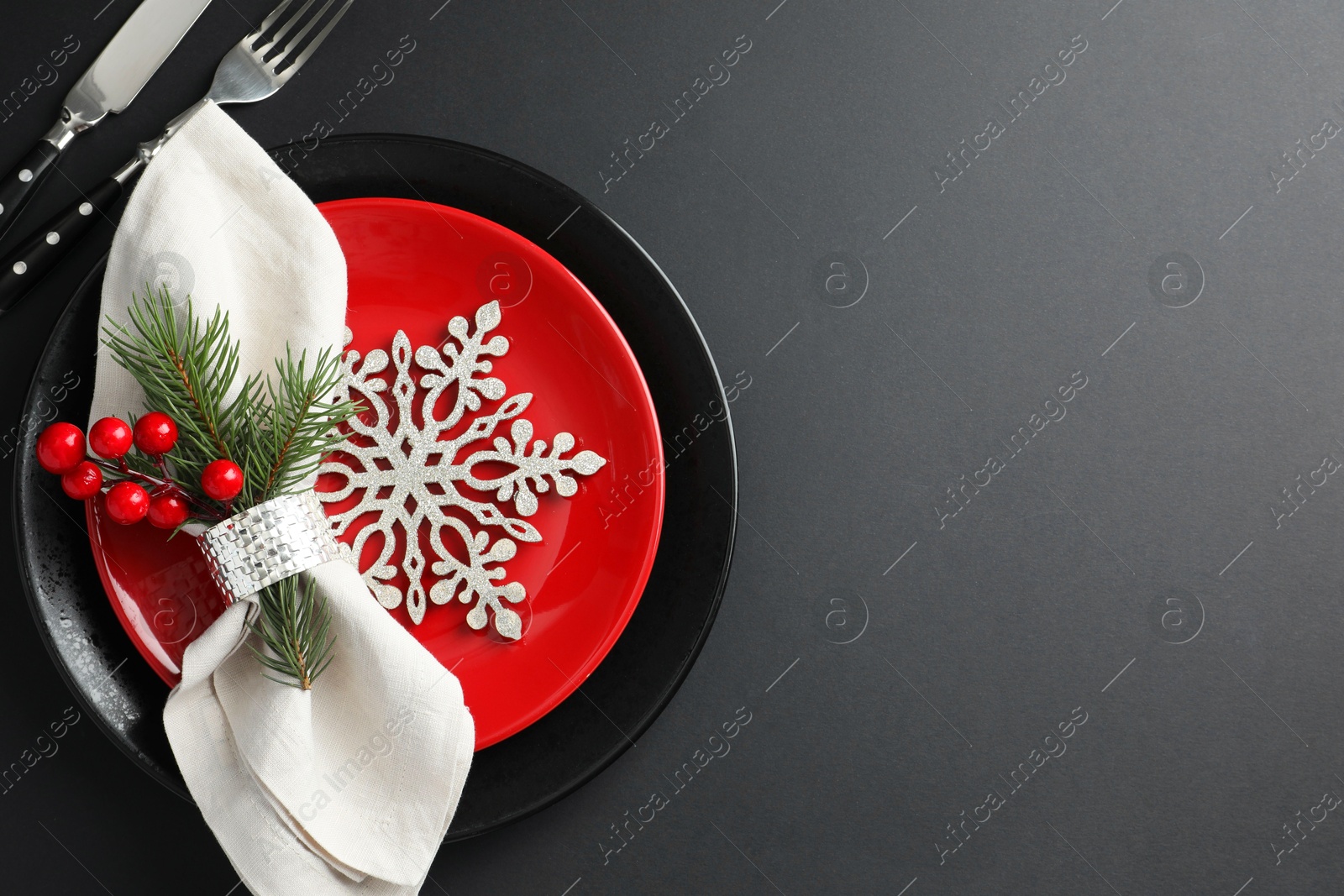 Photo of Christmas setting with festive decor on dark table, flat lay. Space for text