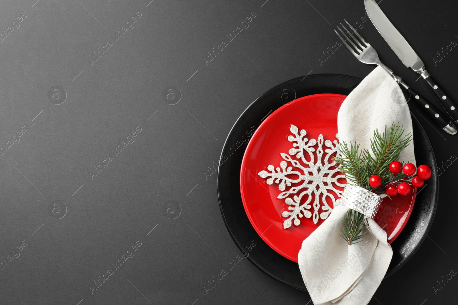 Photo of Christmas setting with festive decor on dark table, flat lay. Space for text