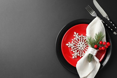 Photo of Christmas setting with festive decor on dark table, flat lay. Space for text