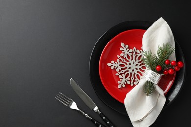 Photo of Christmas setting with festive decor on dark table, flat lay. Space for text