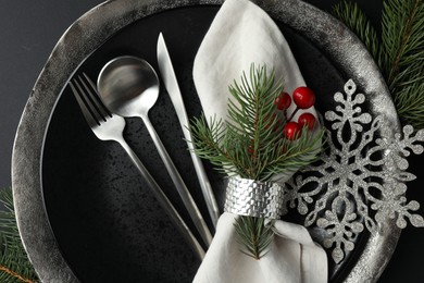 Photo of Christmas setting with festive decor on dark table, flat lay