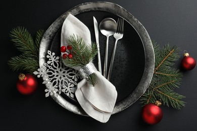 Photo of Christmas setting with festive decor on dark table, flat lay