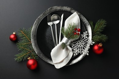 Photo of Christmas setting with festive decor on dark table, flat lay