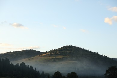 Photo of Picturesque view of fog covering mountains in morning