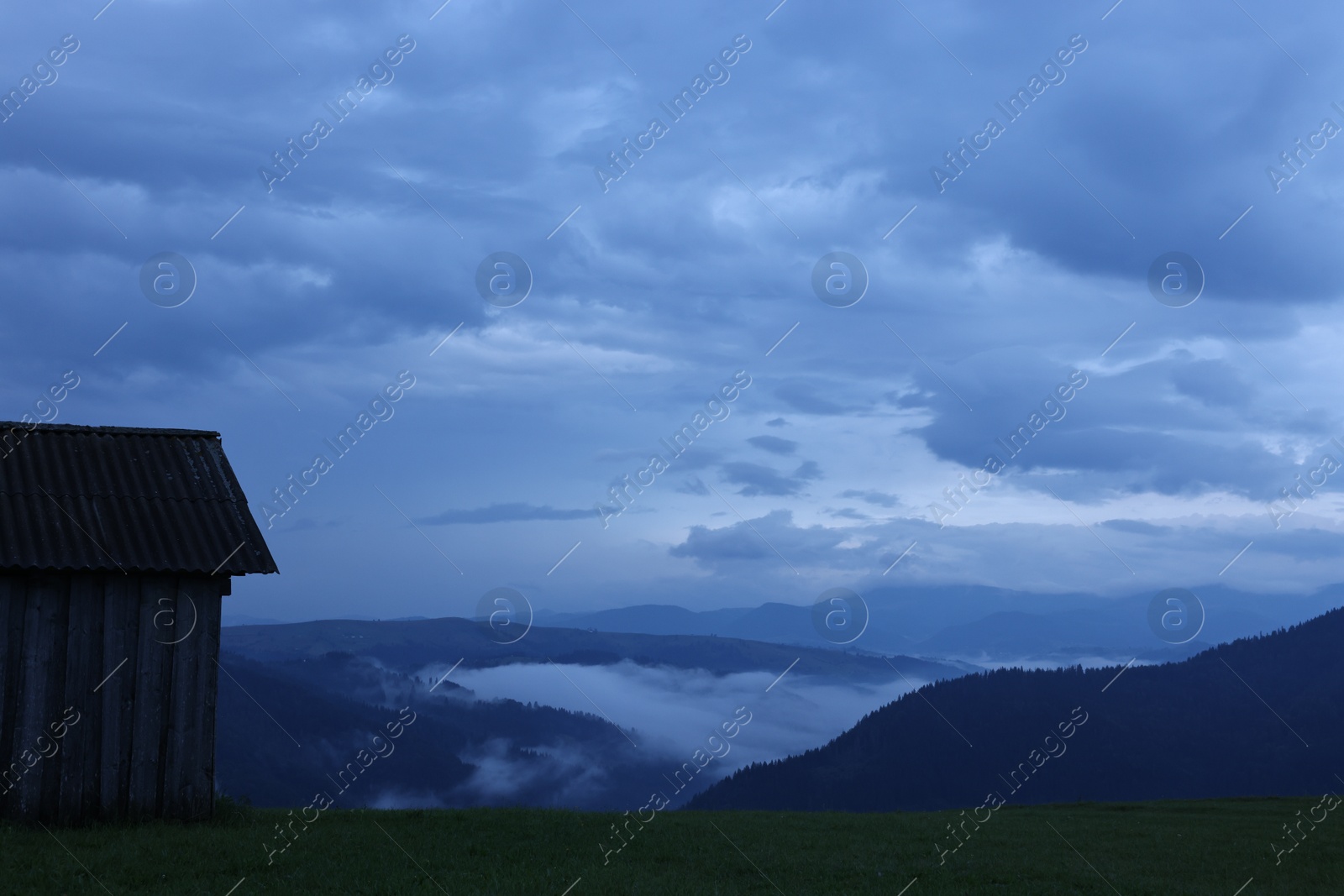 Photo of Picturesque view of beautiful mountains covered with fog