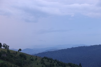 Photo of Picturesque view of beautiful mountains covered with fog