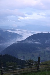 Photo of Picturesque view of beautiful mountains covered with fog