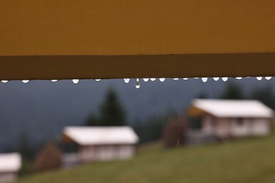 Photo of Roof of building with water droplets outdoors on rainy day, closeup