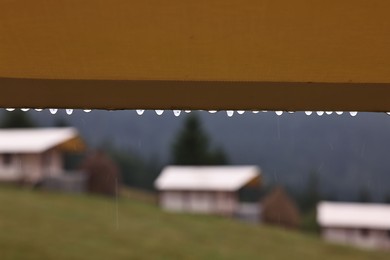 Roof of building with water droplets outdoors on rainy day, closeup