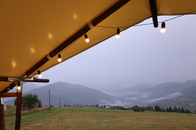 Photo of Roof of building with decorative lights in mountains