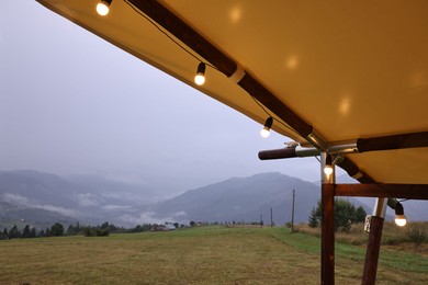 Roof of building with decorative lights in mountains