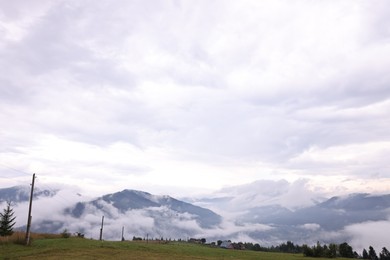 Photo of Picturesque view of beautiful mountains covered with fog