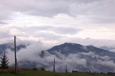 Picturesque view of beautiful mountains covered with fog