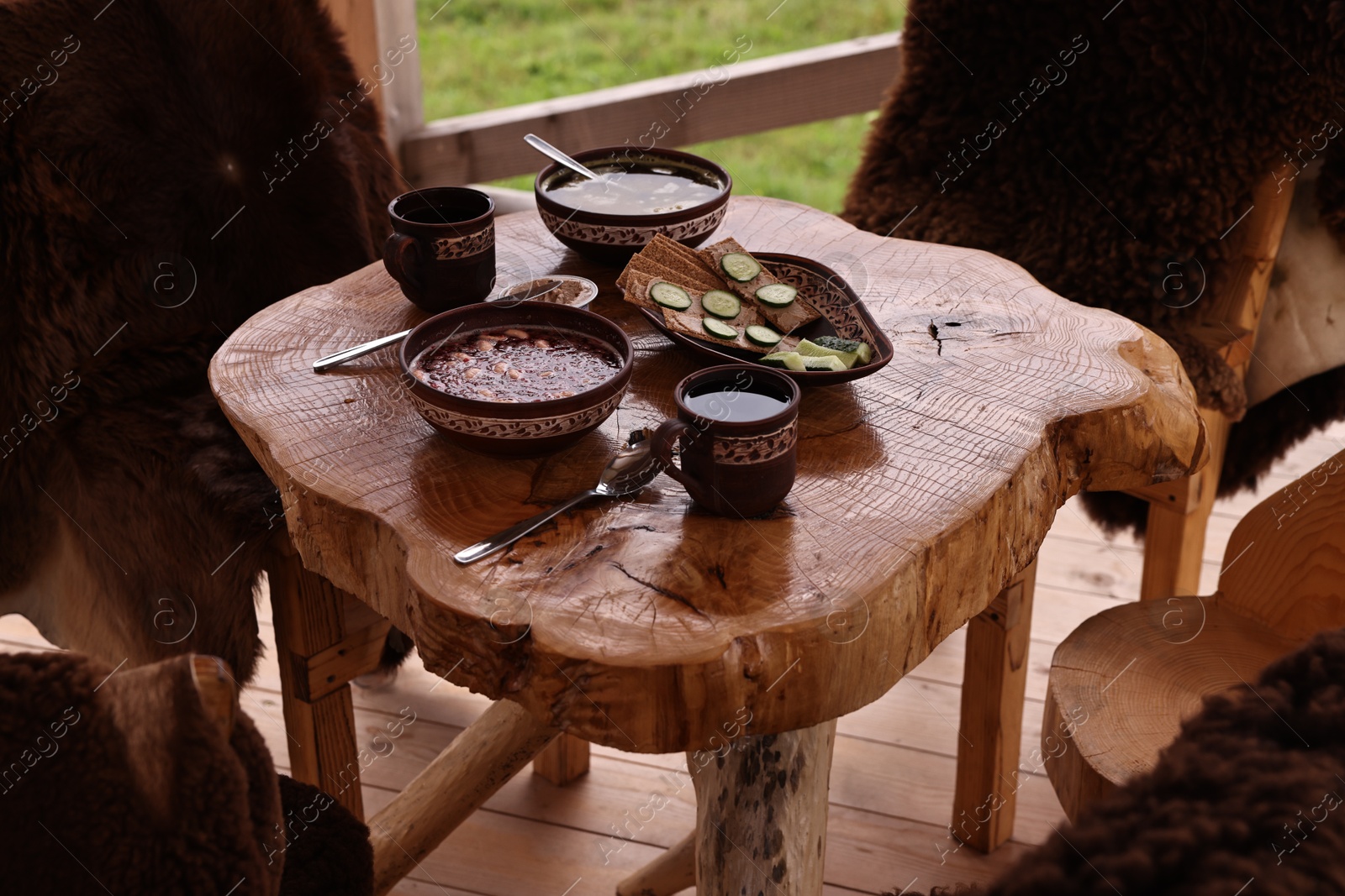 Photo of Different dishes of Ukrainian cuisine on wooden table in cafe