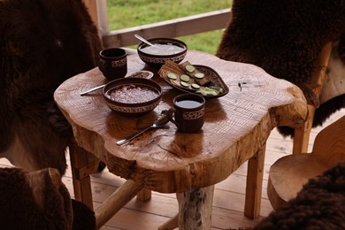 Photo of Different dishes of Ukrainian cuisine on wooden table in cafe