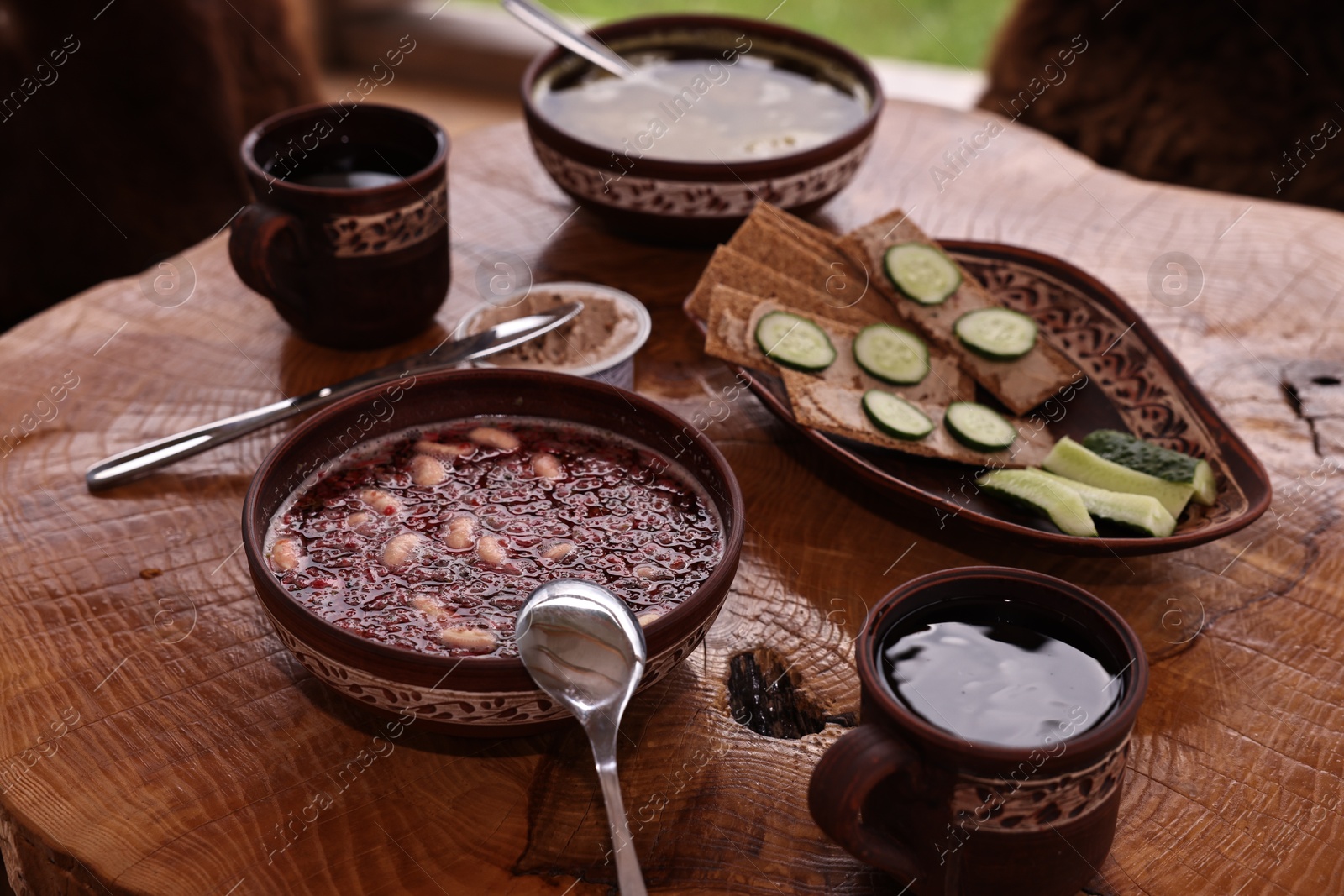 Photo of Different dishes of Ukrainian cuisine on wooden table in cafe