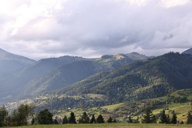 Photo of Picturesque view of beautiful mountains under cloudy sky