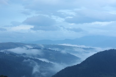 Photo of Picturesque view of beautiful mountains covered with fog