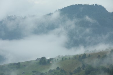 Photo of Picturesque view of beautiful mountains covered with fog