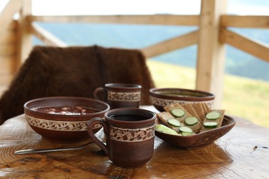 Photo of Different dishes of Ukrainian cuisine on wooden table in cafe