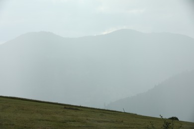 Picturesque view of beautiful mountains covered with fog