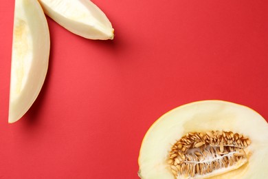 Fresh cut melon on red background, flat lay