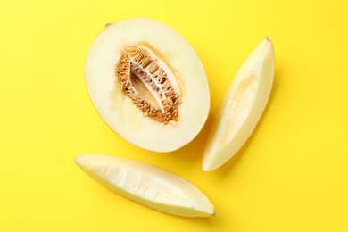 Fresh cut melon on yellow background, flat lay