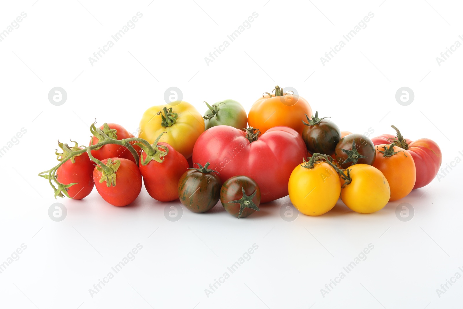 Photo of Different sorts of fresh ripe tomatoes isolated on white