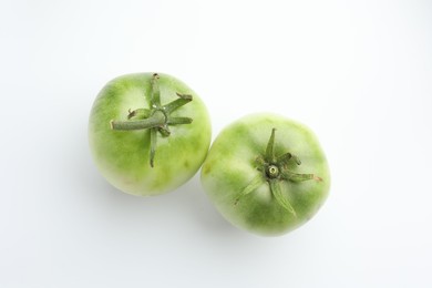 Photo of Fresh unripe tomatoes isolated on white, top view