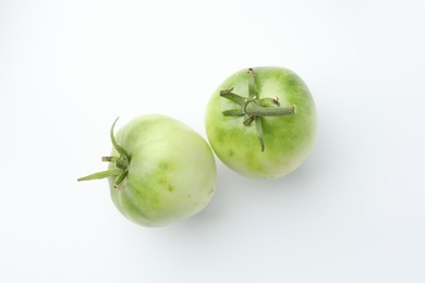 Photo of Fresh unripe tomatoes isolated on white, top view