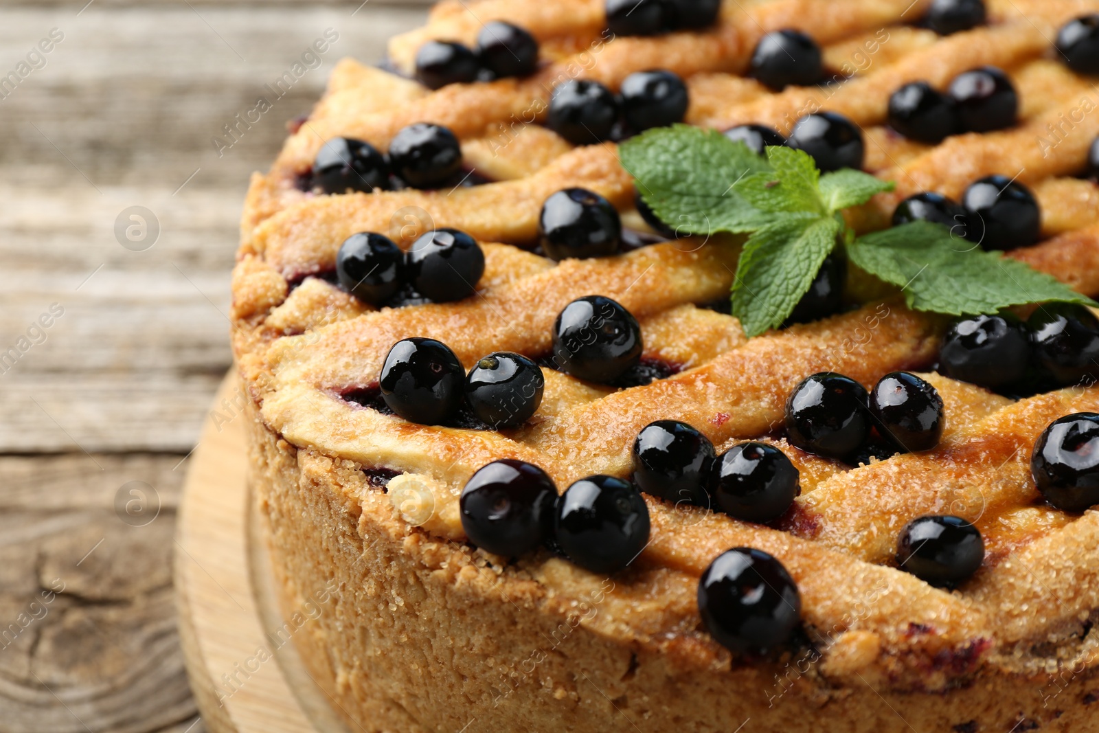 Photo of Delicious homemade blueberry pie with mint on table, closeup