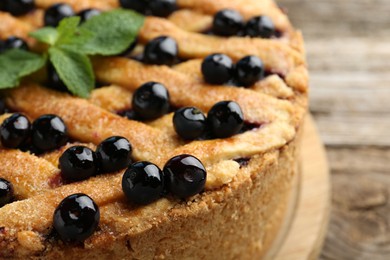 Photo of Delicious homemade blueberry pie with mint on table, closeup