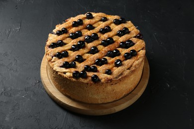 Photo of Delicious homemade blueberry pie on black table