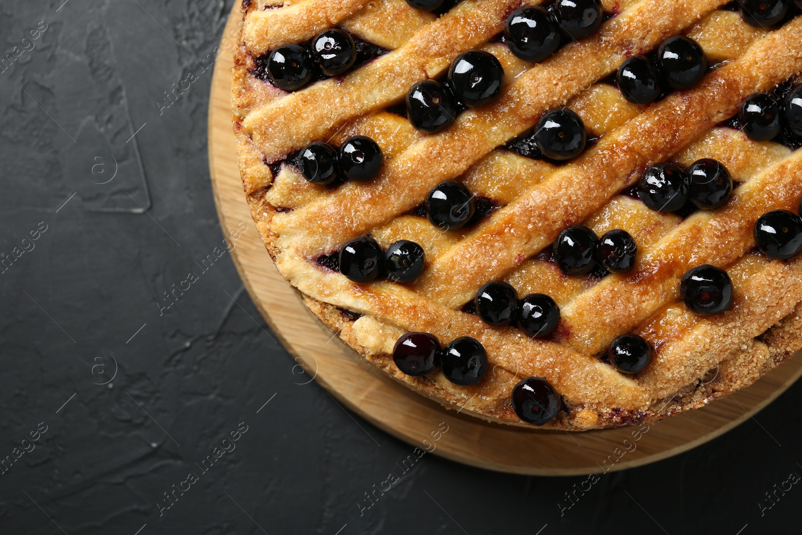 Photo of Delicious homemade blueberry pie on black table, top view