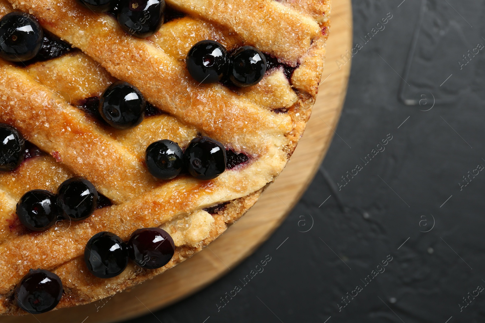 Photo of Delicious homemade blueberry pie on black table, top view