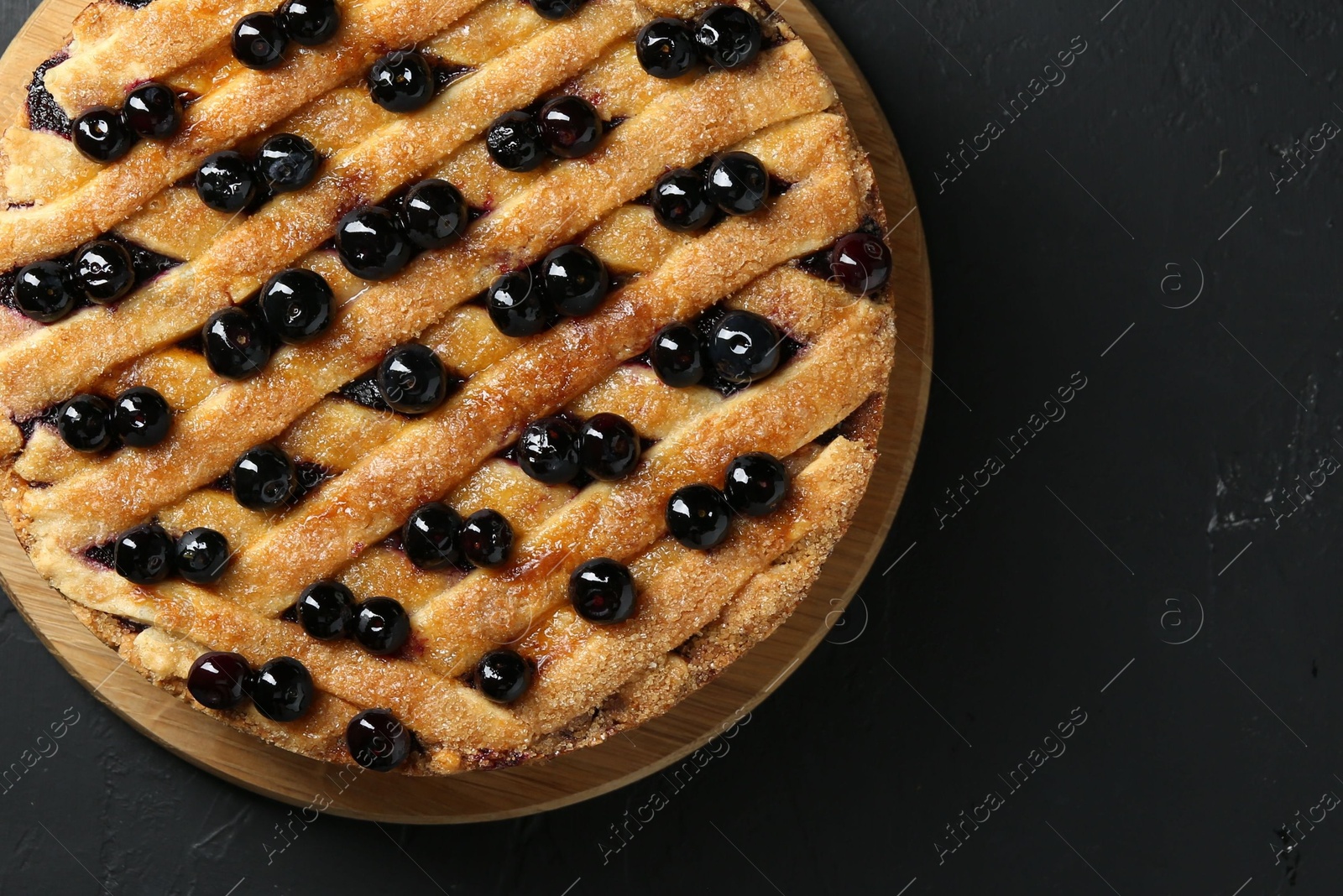 Photo of Delicious homemade blueberry pie on black table, top view