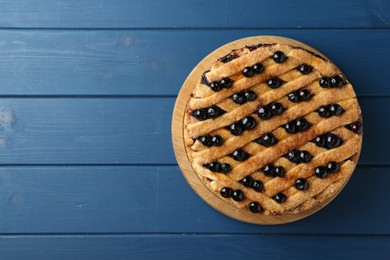 Photo of Delicious homemade blueberry pie on blue wooden table, top view. Space for text