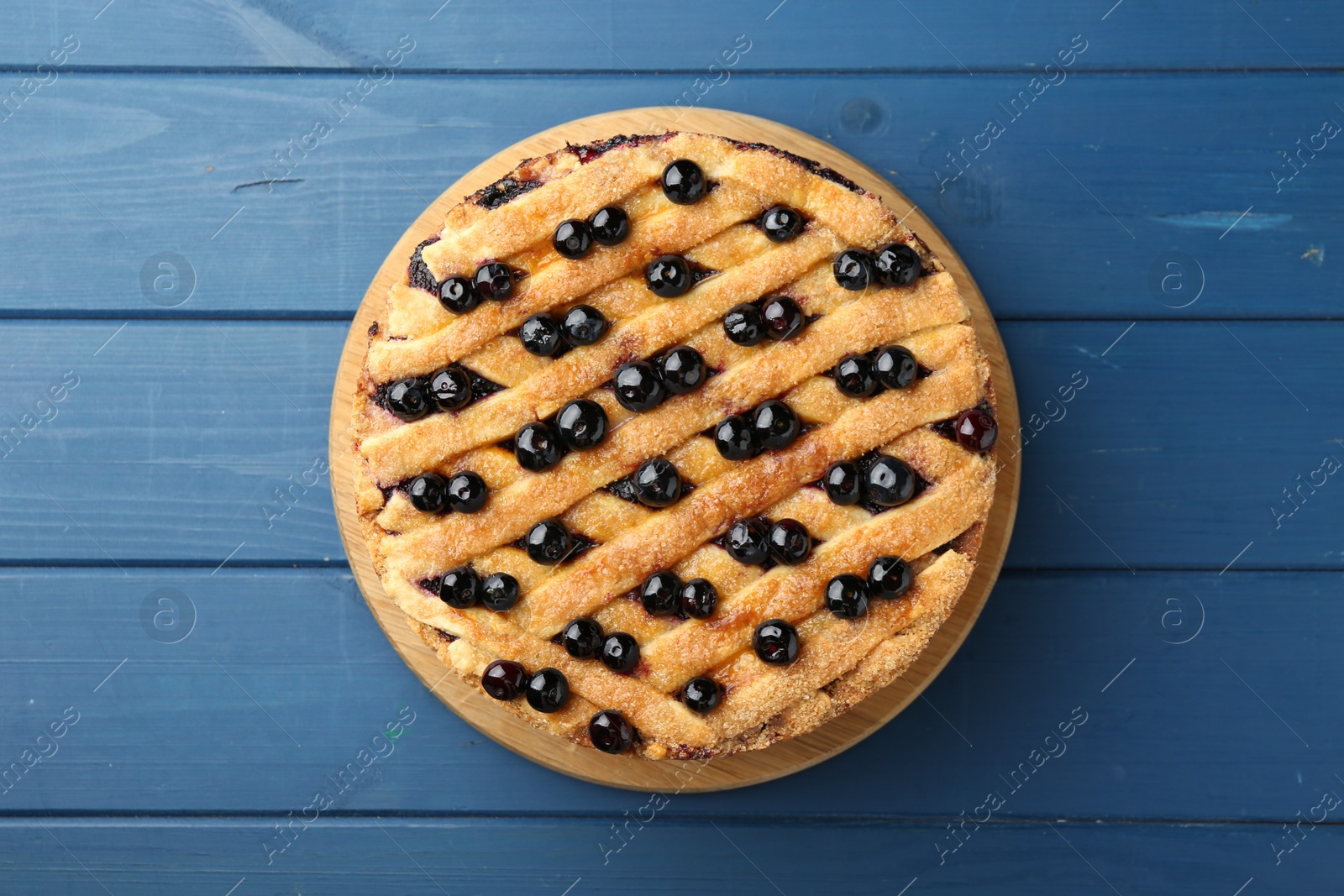 Photo of Delicious homemade blueberry pie on blue wooden table, top view