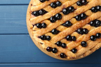 Photo of Delicious homemade blueberry pie on blue wooden table, top view